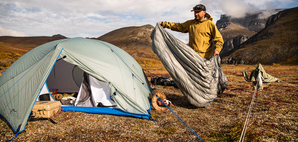 Hunter with Stone Glacier tent and sleeping bag