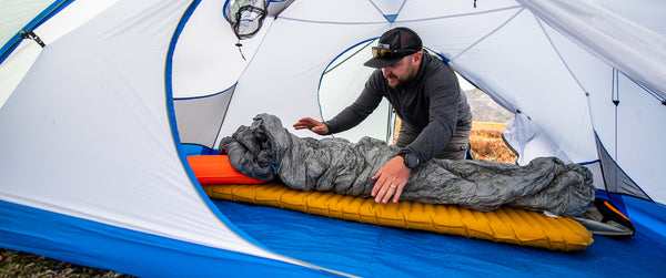 Hunter in Stone Glacier tent with sleeping bag