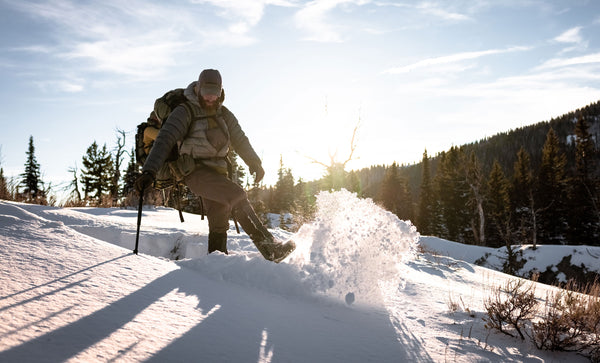 hiker kicking snow in gaiters