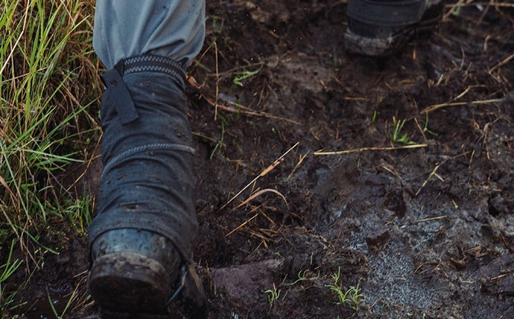 Man hunting in mud with gaiters on his boots